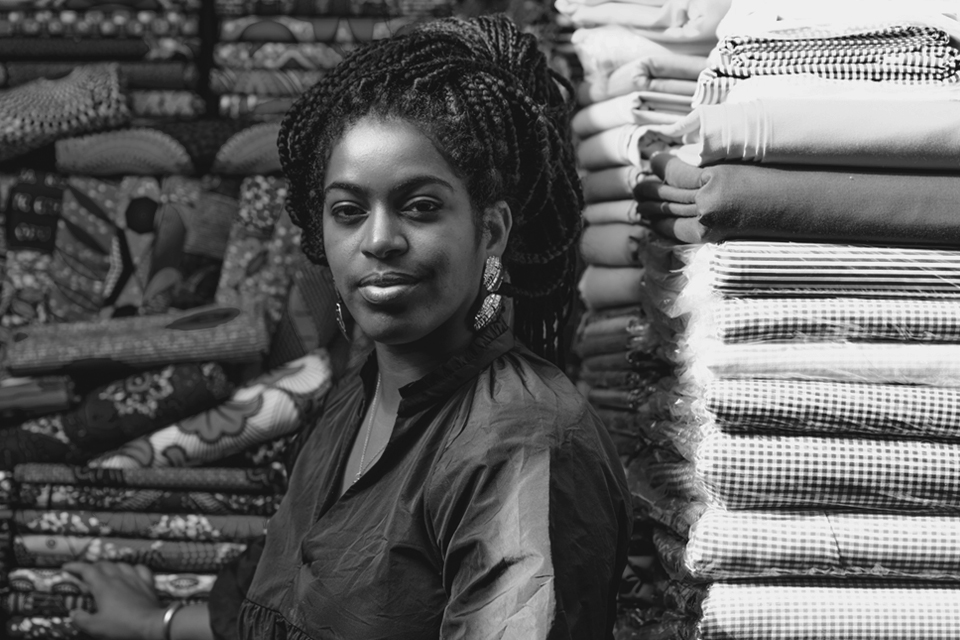 Woman posing in front of textiles