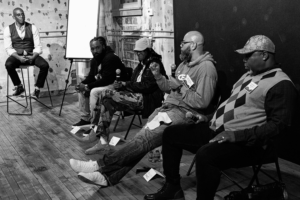A group together listening to a man speaking.
